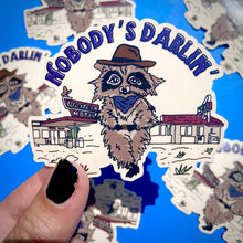 Load image into Gallery viewer, Cowboy Raccoon &quot;Nobody&#39;s Darlin&#39;&quot; Water Bottle Sticker
