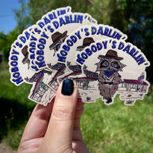 Load image into Gallery viewer, Cowboy Raccoon &quot;Nobody&#39;s Darlin&#39;&quot; Water Bottle Sticker
